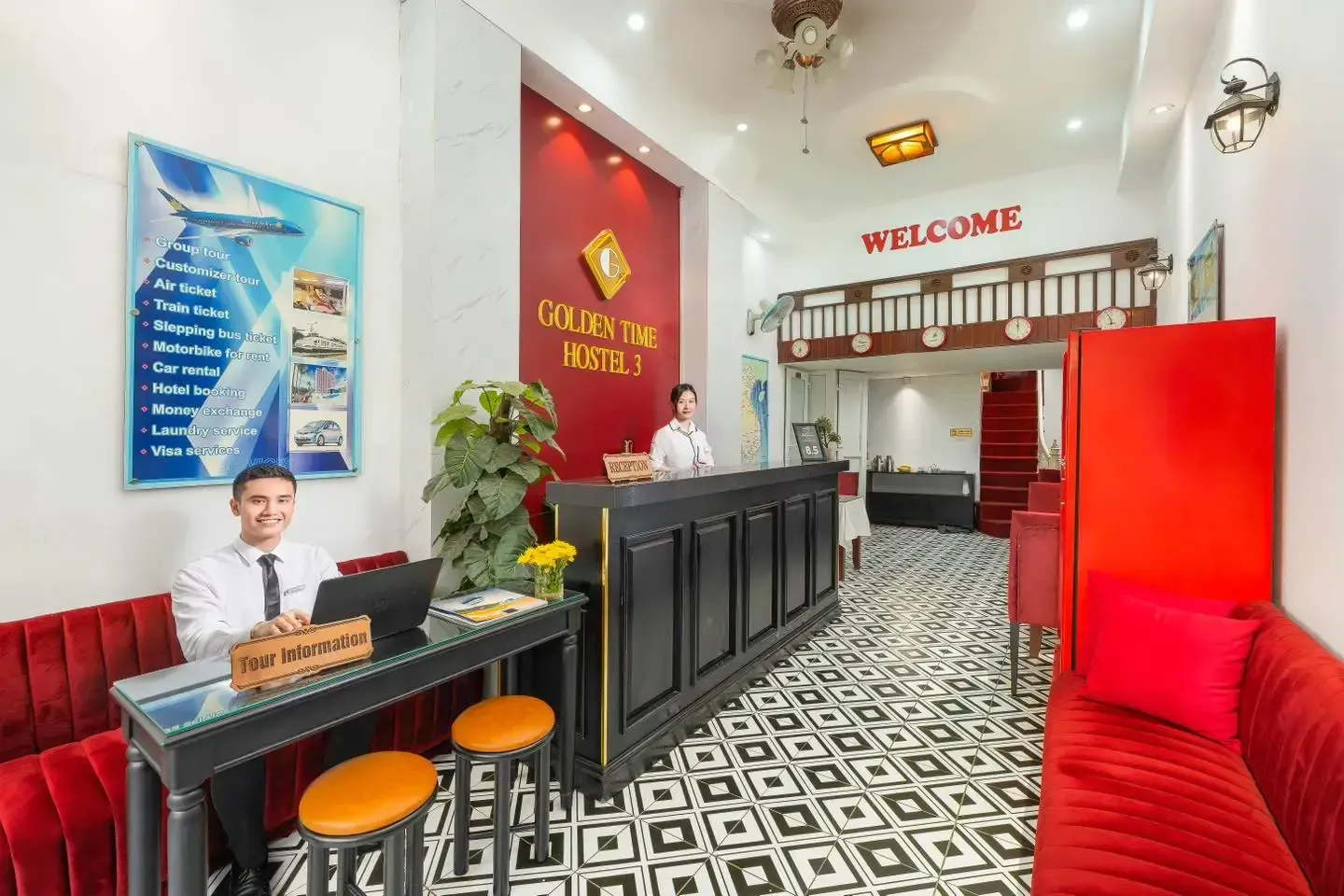 Golden Time Hostel 3 reception desk with warm red velvet sofas and friendly staff