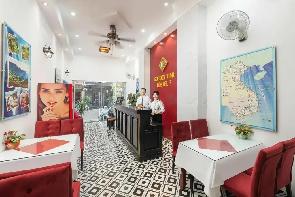 Cozy breakfast and reception area with red chairs and a map of Vietnam